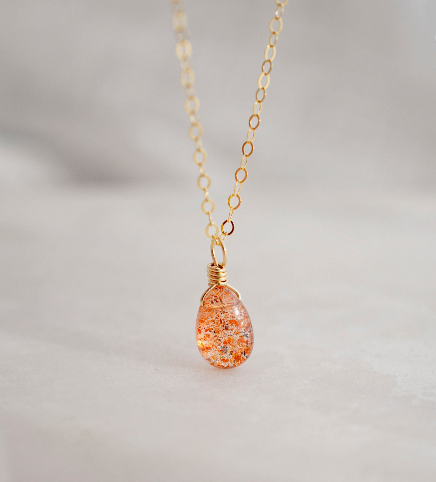 Orange Sunstone smooth polished teardrop pendant on a 14k gold filled chain. Stones shimmer in the light and when turned from side to side. 