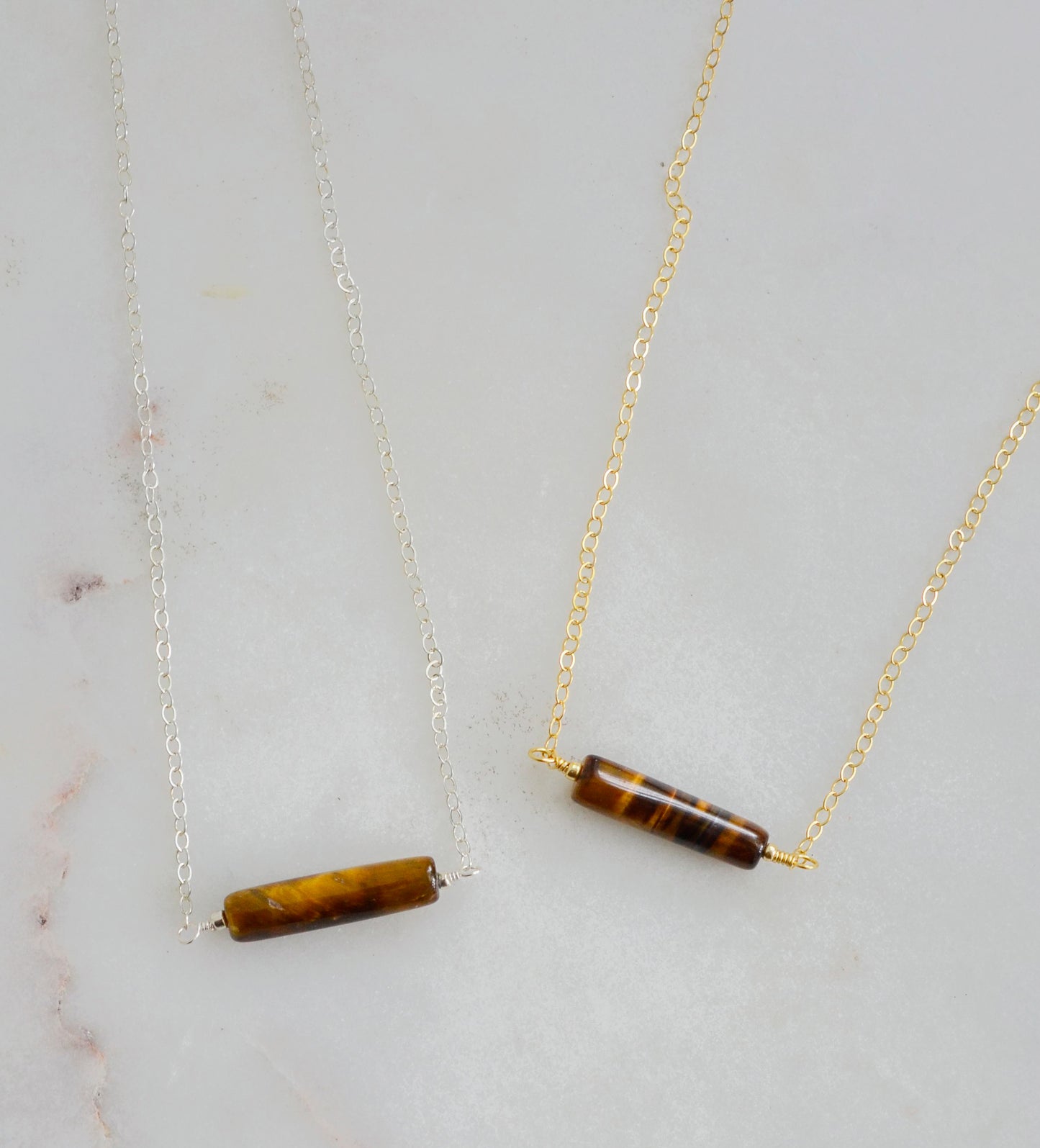 Tiger Eye gemstone necklace. A smooth polished Tiger Eye stone in a bar or tube shape shown in the sterling silver an 14k gold filled chain styles.