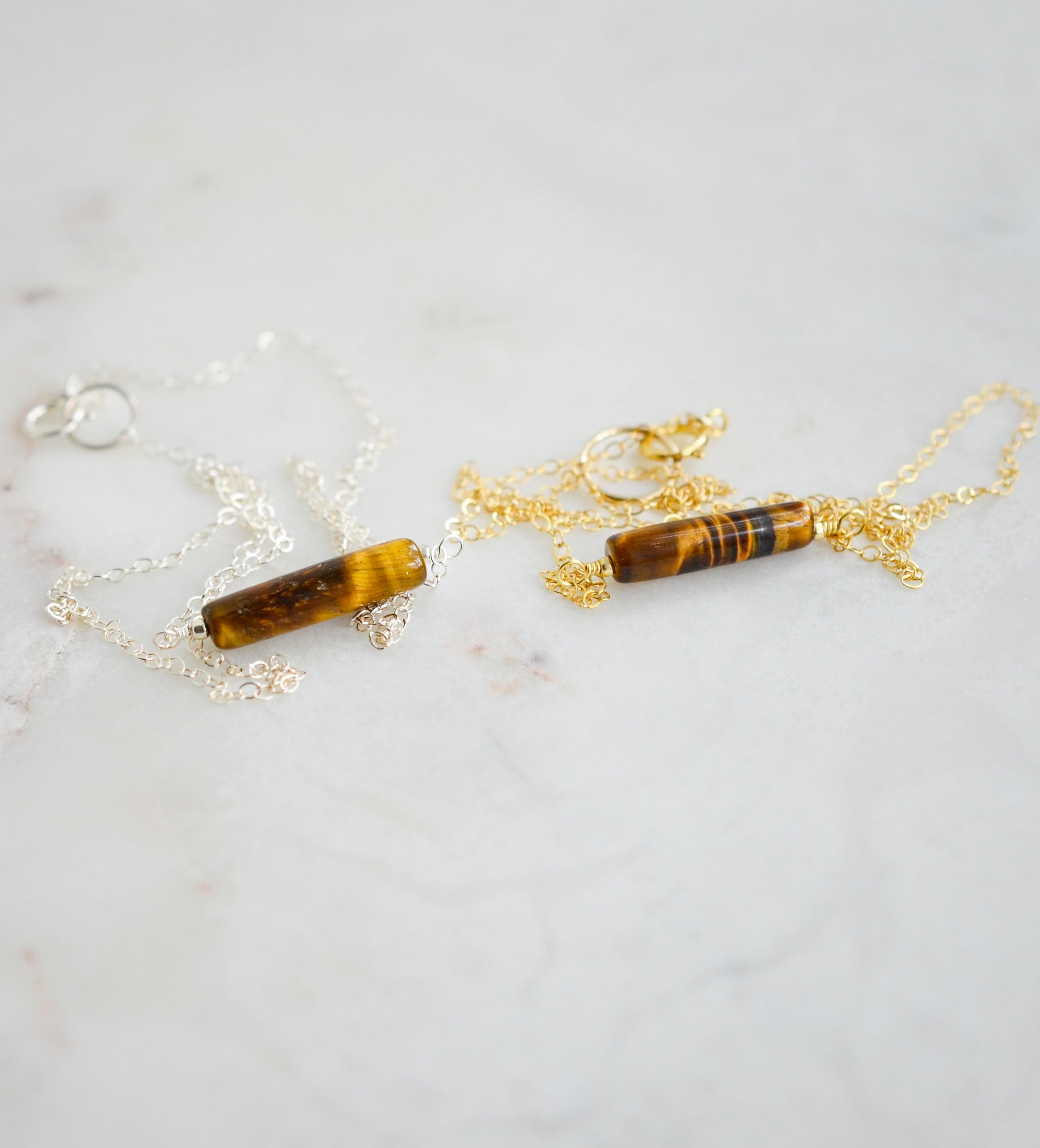 Tiger Eye gemstone necklace. A smooth polished Tiger Eye stone in a bar or tube shape shown in both sterling silver and 14k gold filled chains.