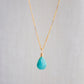 Bright natural Arizona Turquoise teardrop suspended from a 14k gold filled chain. Close up image. 