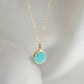 Round aqua blue Turquoise set into a gold bezel and suspended from a 14k gold filled chain.