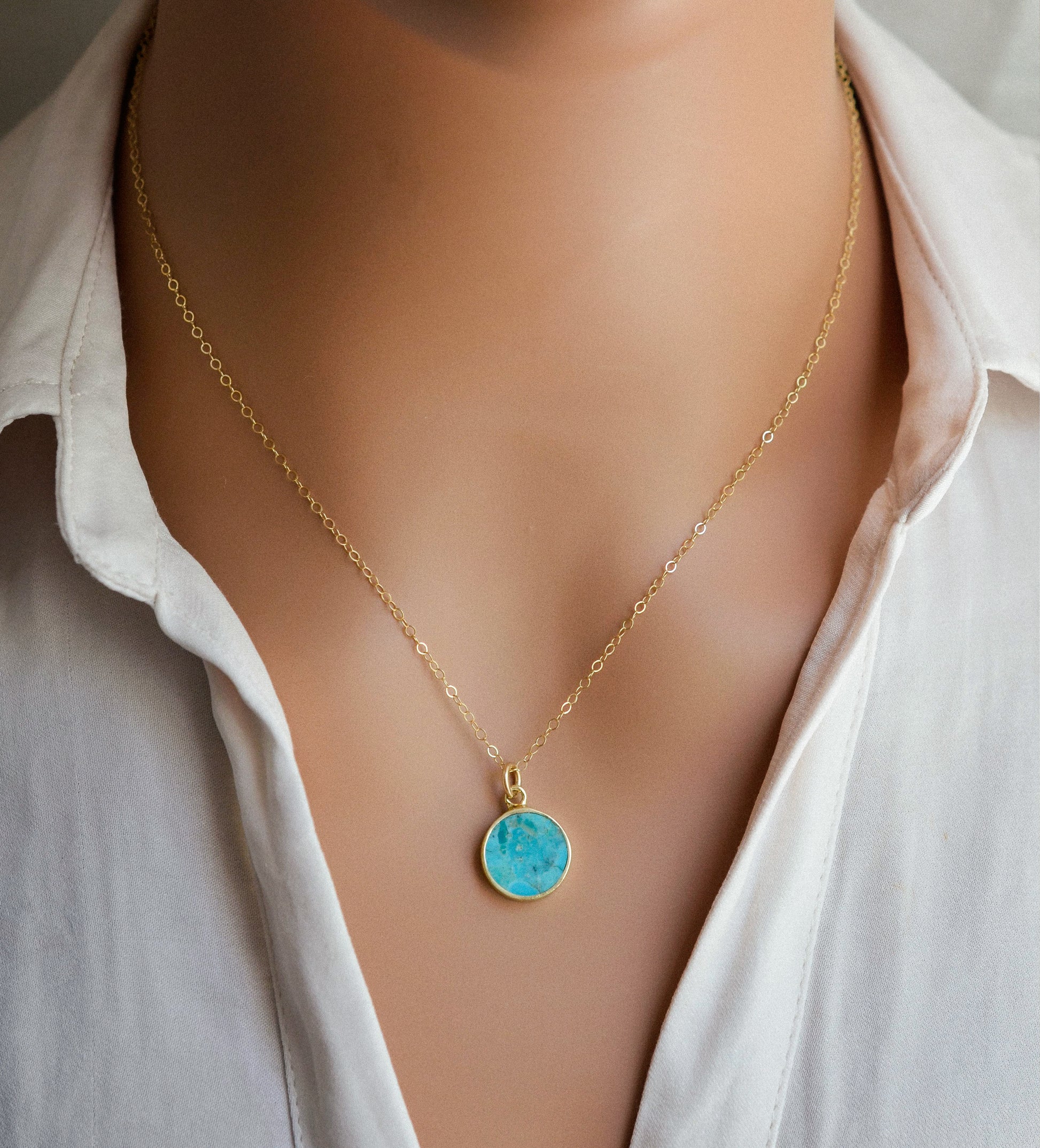 Round aqua blue Turquoise set into a gold bezel and suspended from a 14k gold filled chain.