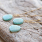 Aqua blue amazonite slice gemstone set onto a sterling silver  or 14k gold filled chains. The stone is semi oval in shape, but irregular. It's smooth polished, but with raw edges. 