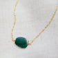 Natural green Malachite smooth polished slice with raw edges. Each stone is an irregular oval shape and has a variety of banding. Shown on a 14k gold filled chain.
