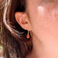 Genuine orange sunstone teardrop dangle earrings shown in 14k gold filled. The gemstones are smooth polished. Modeled image.