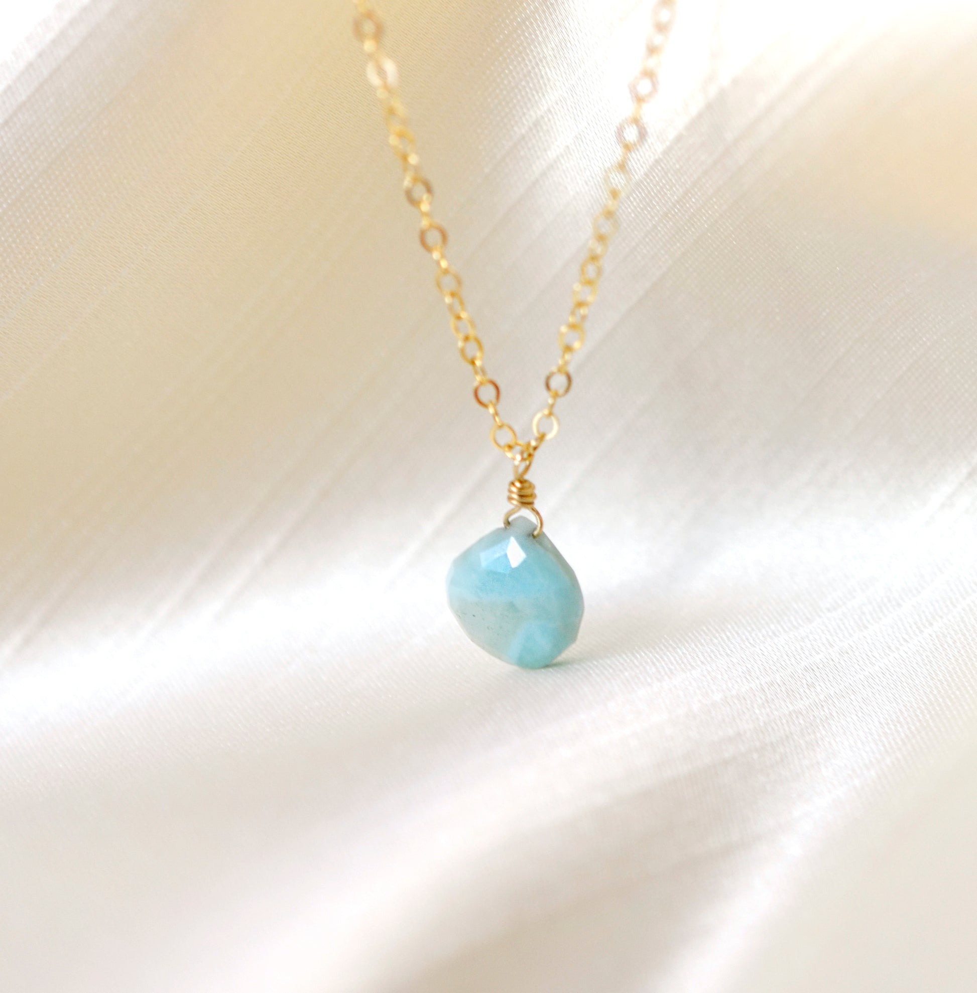 Natural aqua-blue Larimar faceted teardrop pendant set onto a 14k gold filled chain.