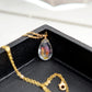 Rainbow hues shown within the Mystic Topaz. The gemstone is a faceted teardrop shape. The 14k gold filled style is shown.