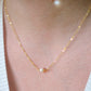 Single round white freshwater pearl necklace on a 14k gold filled chain. Modeled image. 