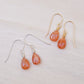 Genuine orange sunstone teardrop dangle earrings shown in 14k gold filled and sterling silver. The gemstones are smooth polished. 