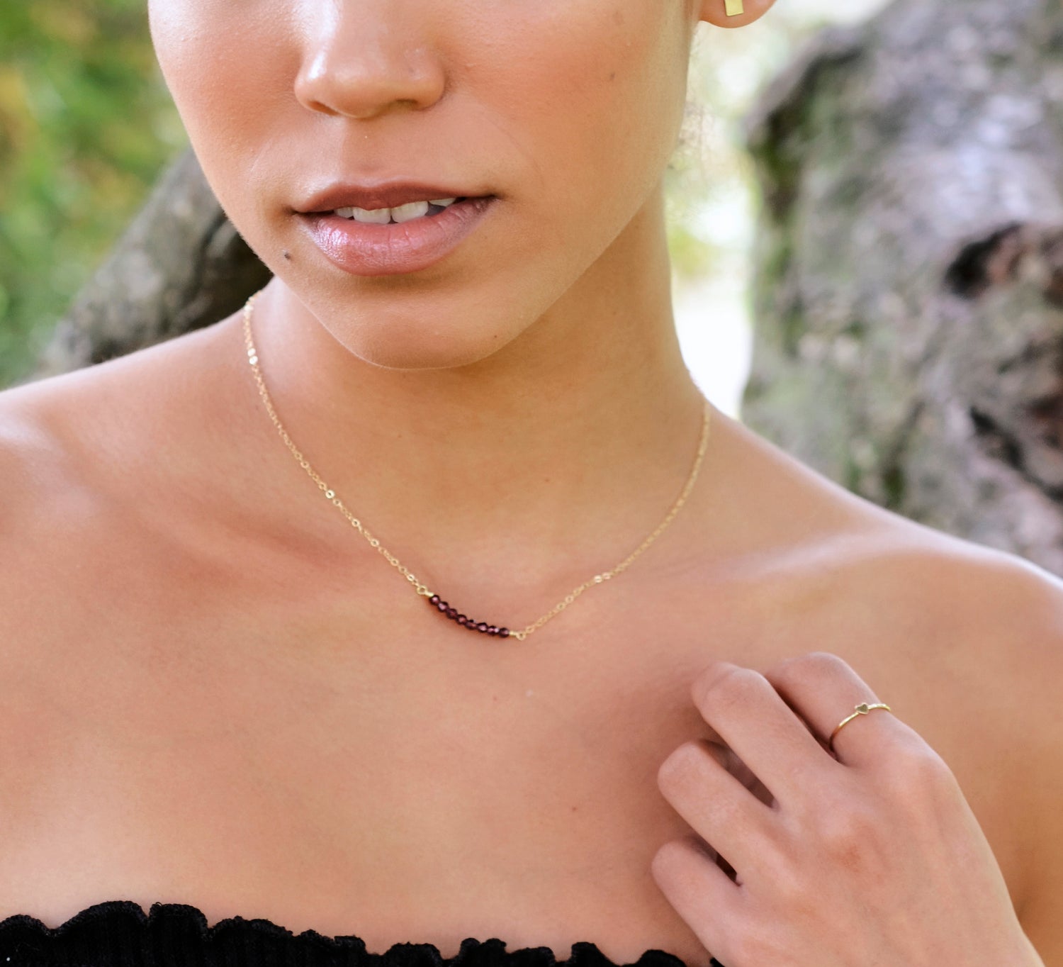 Dainty red garnet bar necklace in gold.