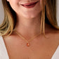 Orange Sunstone smooth polished teardrop pendant on a 14k gold filled chain. Modeled on a 16 inch chain.