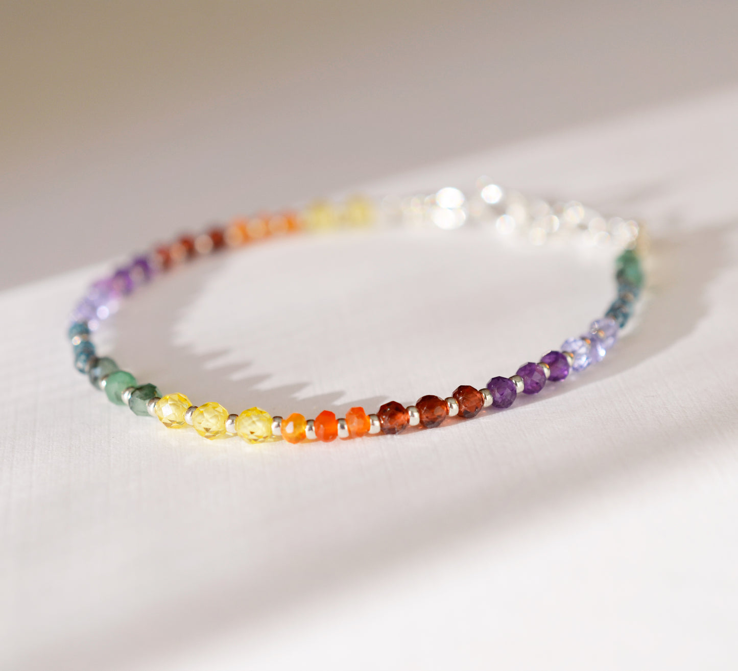 Handmade real gemstone bracelet for the Chakras or Pride. Stones include: Garnet, amethyst, topaz, emerald, carnelian, CZ, and tanzanite.