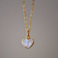 Natural rainbow moonstone heart pendant set onto a sterling silver or gold filled chain. Small stone heart pendant. 