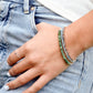 A woman wearing three layered beaded gemstone bracelets. Each bracelet is handmade in Connecticut with natural crystals and is perfect for everyday wear.