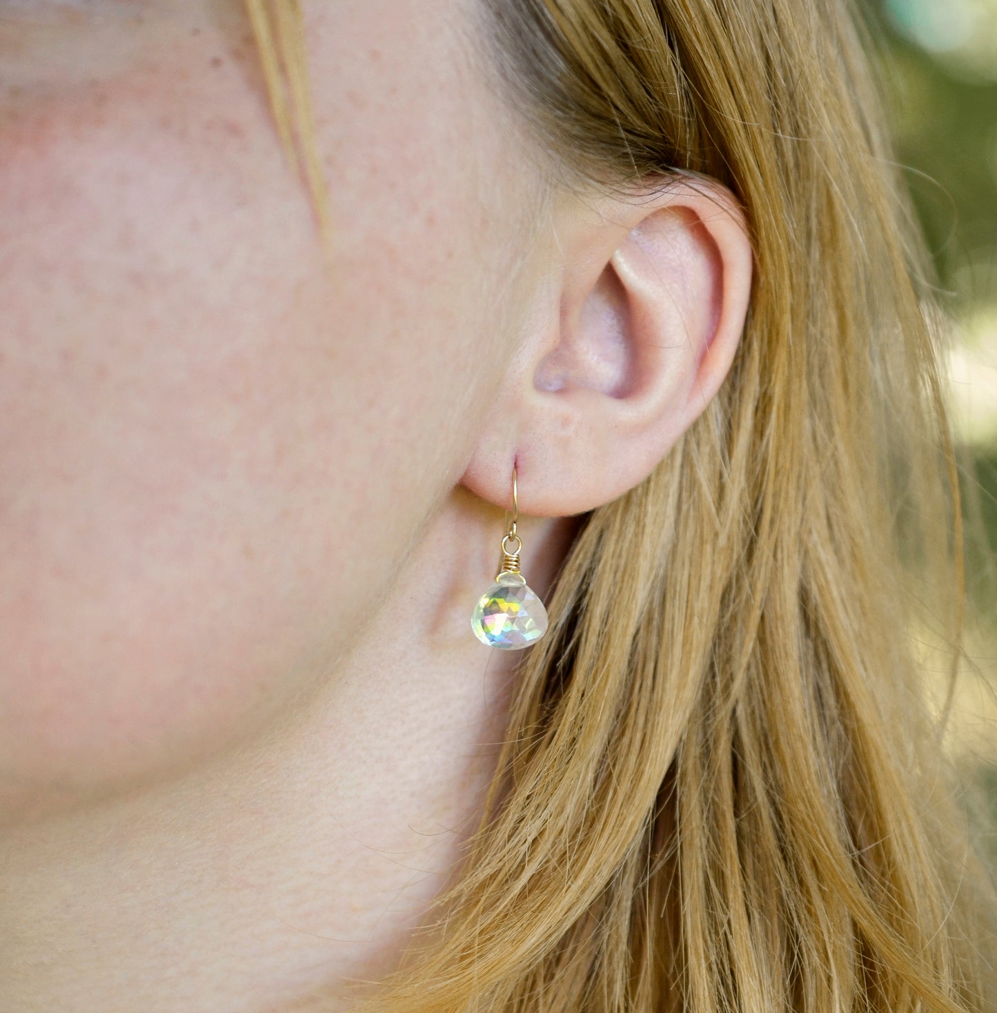 Mystic Topaz earrings modeled in 14k gold filled. The gemstone is a faceted heart briolette teardrop shape.