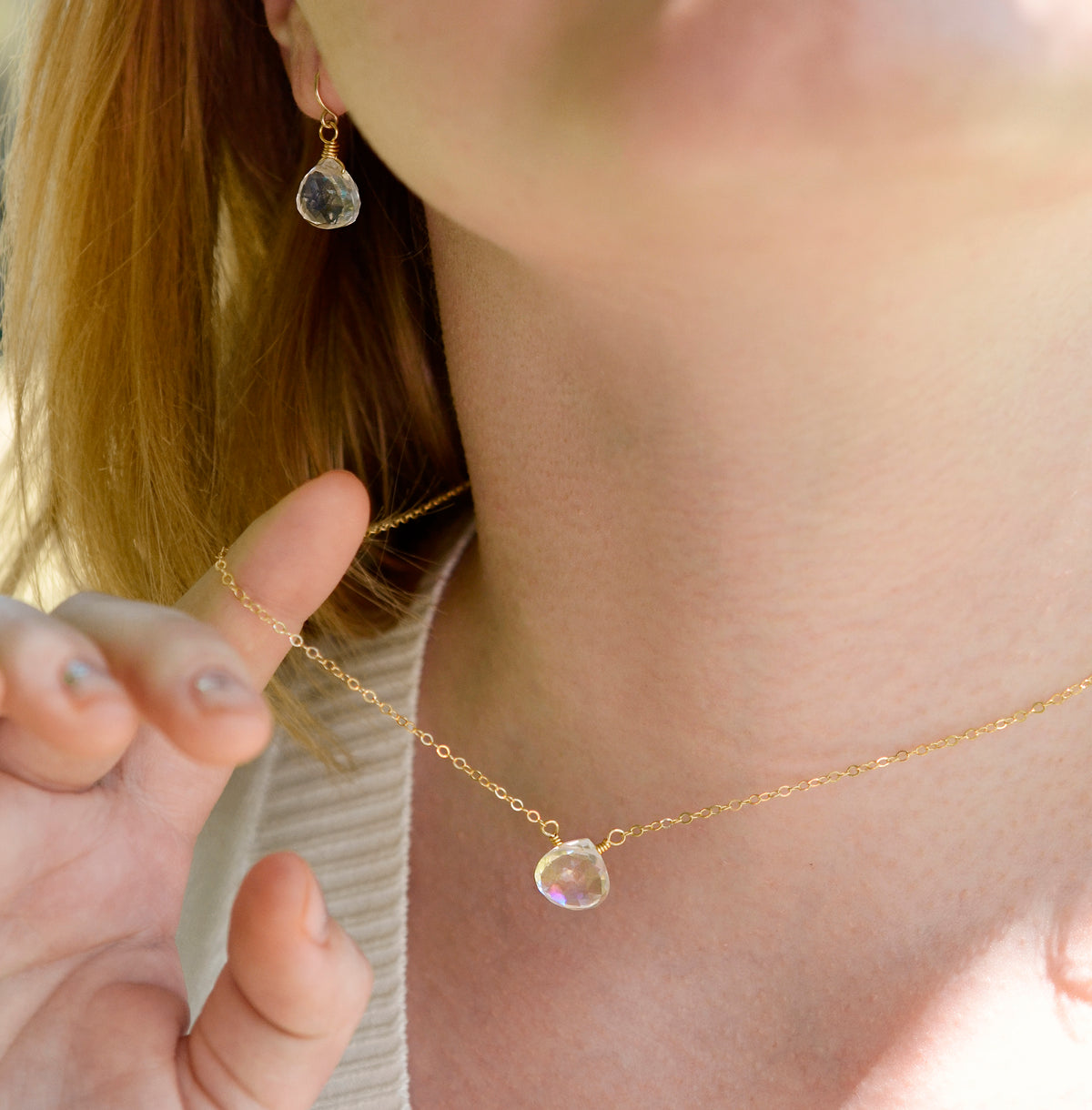 Close up of the rainbow colors in the Mystic Topaz crystal. The 14k gold filled style is shown. Modeled with matching earrings.