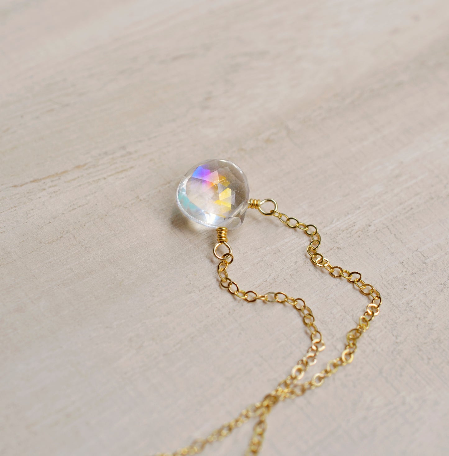 Close up of the rainbow colors in the Mystic Topaz crystal. The 14k gold filled style is shown.