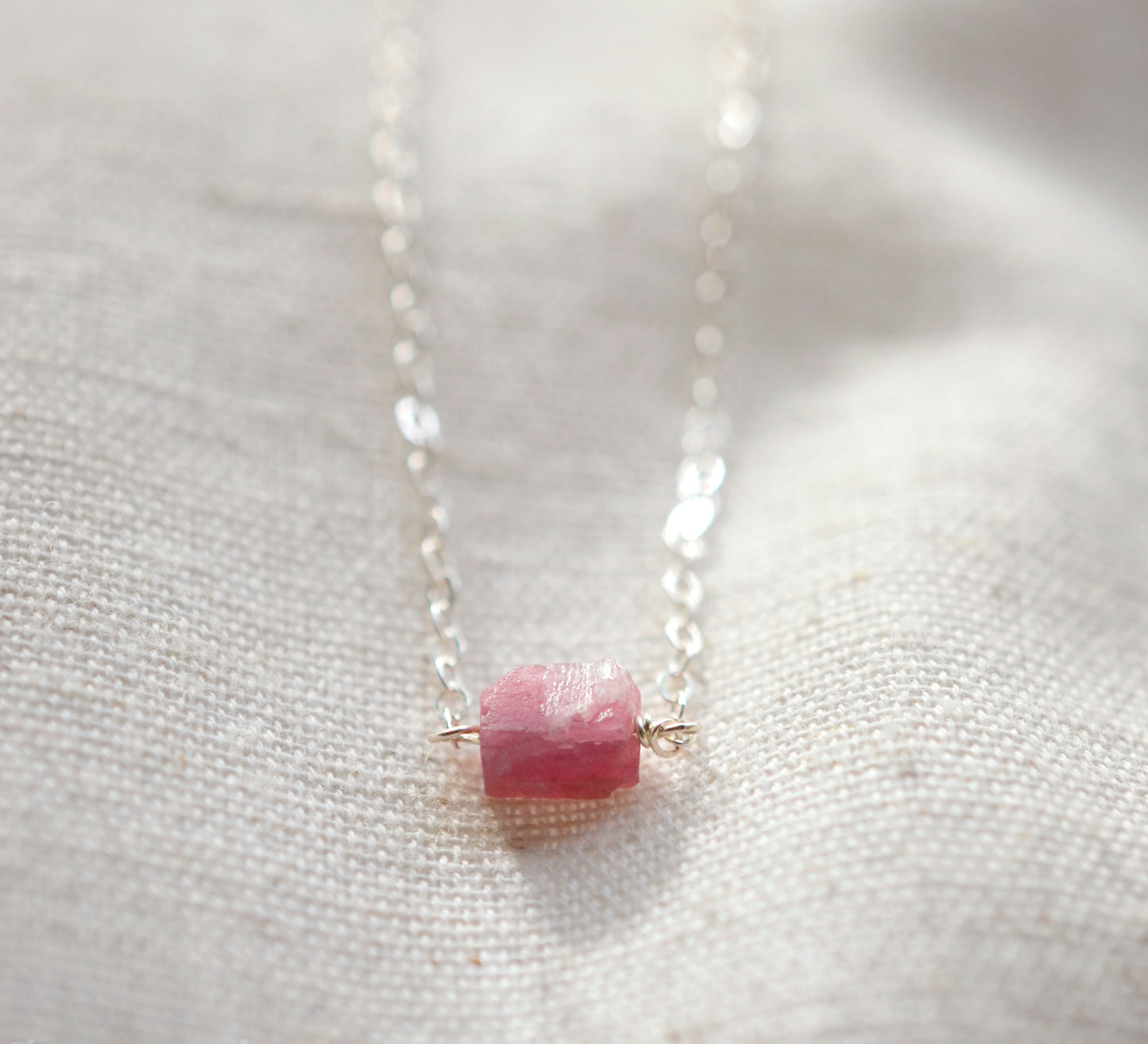 Small natural pink tourmaline crystal set onto a sterling silver chain. 