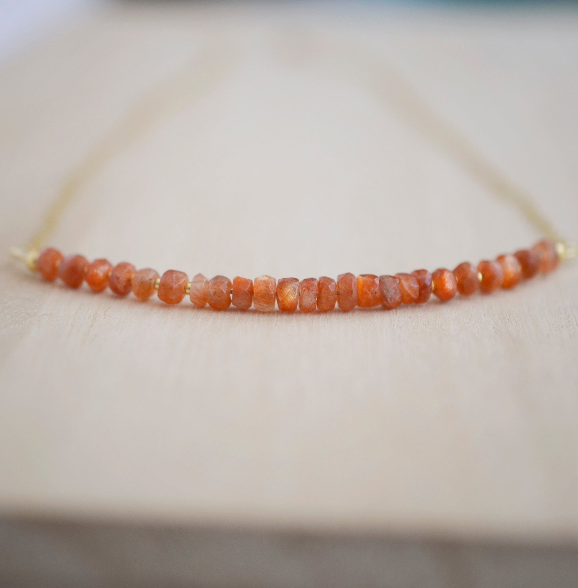 Sunstone Necklace with small faceted sunstone gems set onto a sterling silver or gold filled chain. 